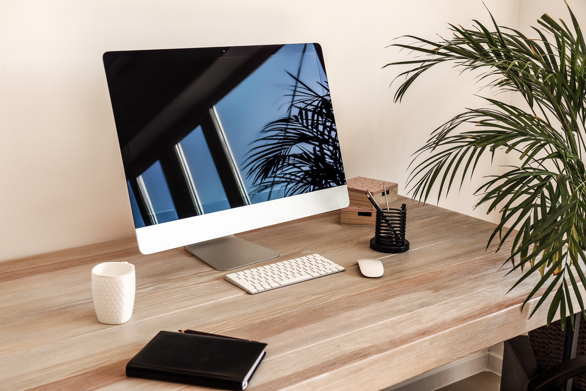 Modern Computer on Wooden Table near Light Wall